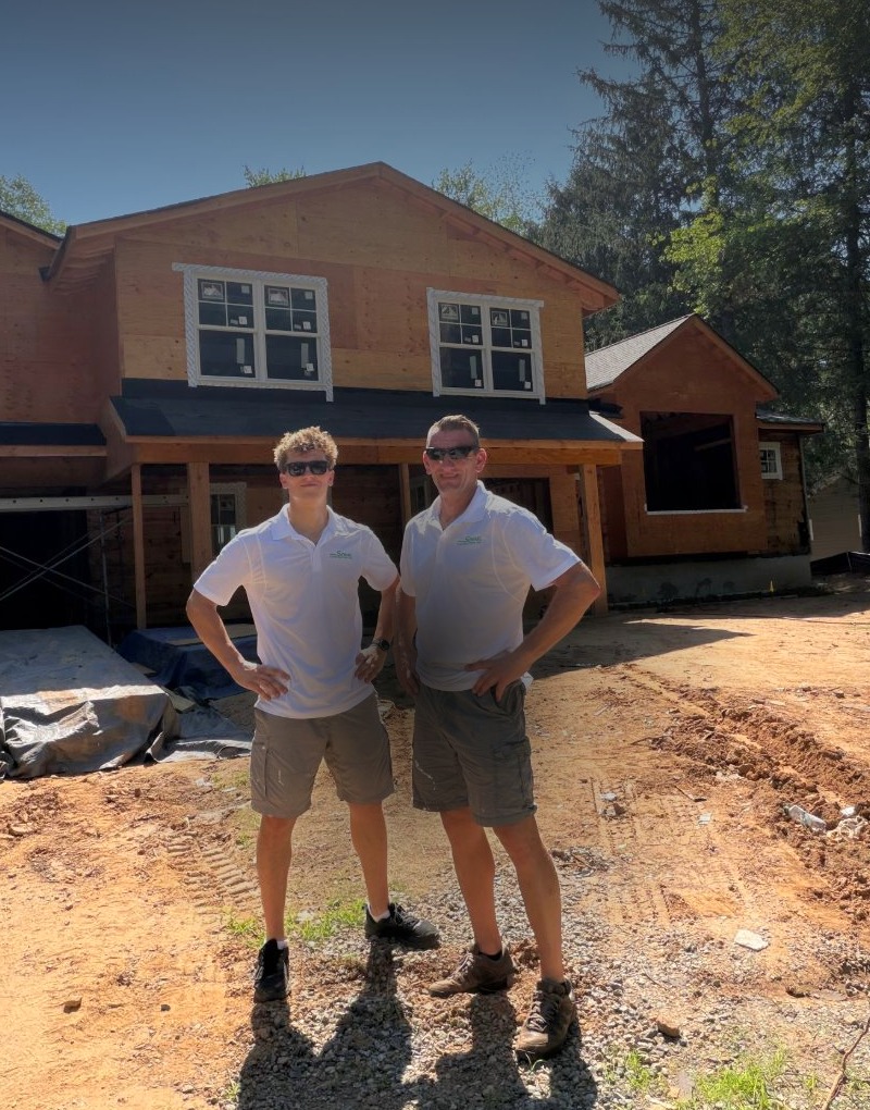 The father-and-son team behind Szwarc Construction standing at a Garfield, NJ job site